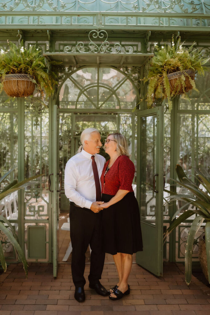 Wedding guests holding hands and smiling at each other 