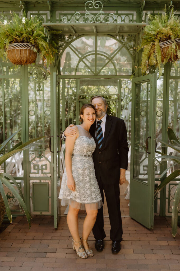 Two people with their arms around each other smiling 