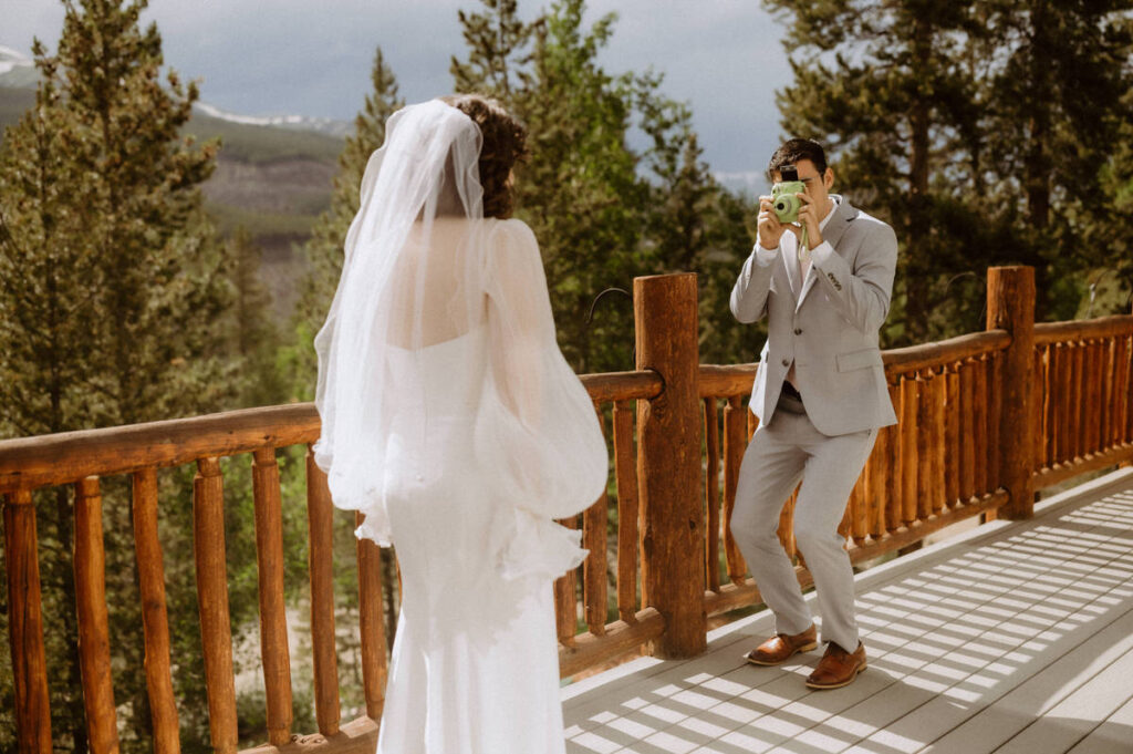 A person taking a polaroid of their partner on their wedding day 