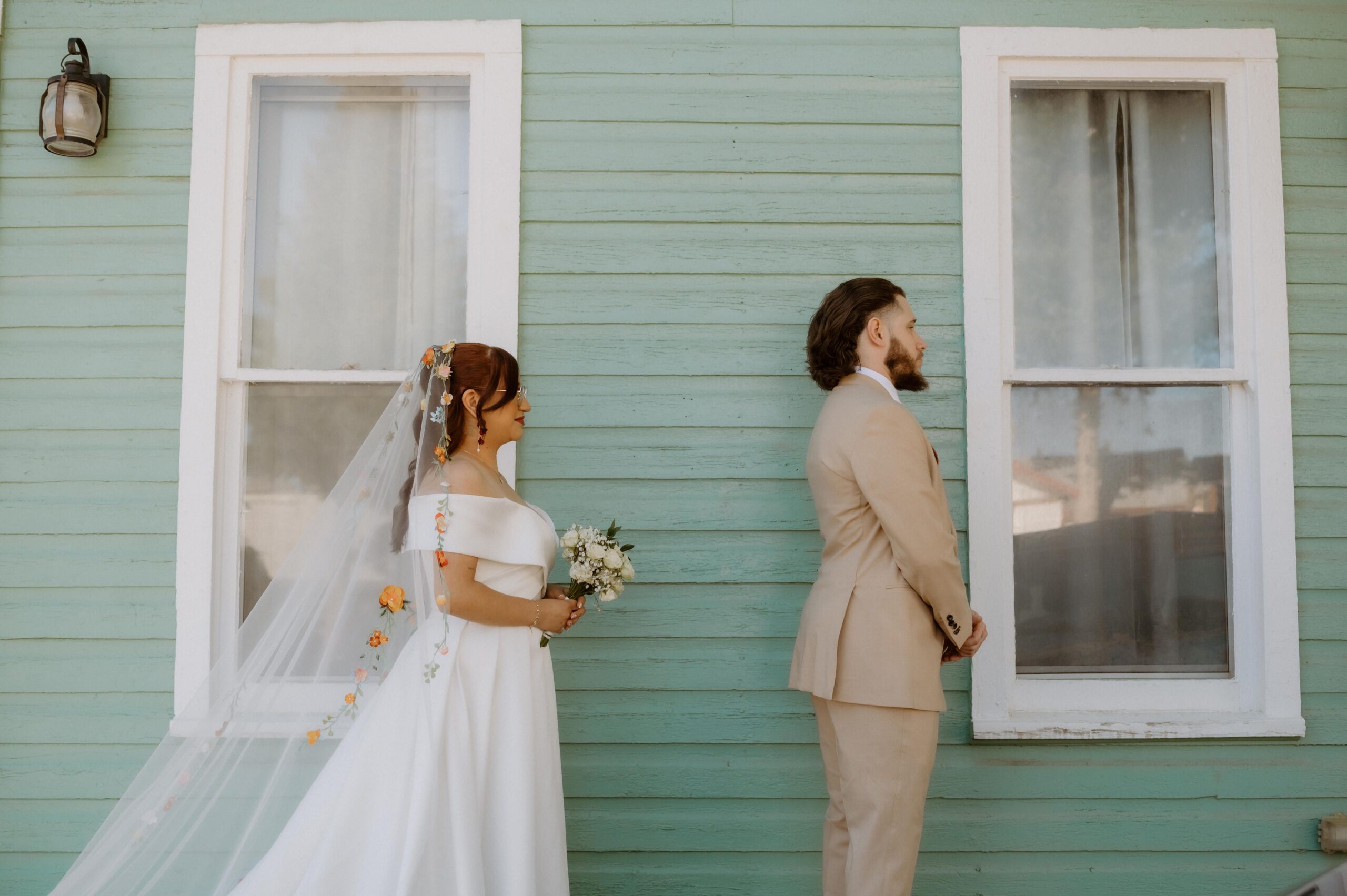 a man and woman having a first look on the day of their wedding 