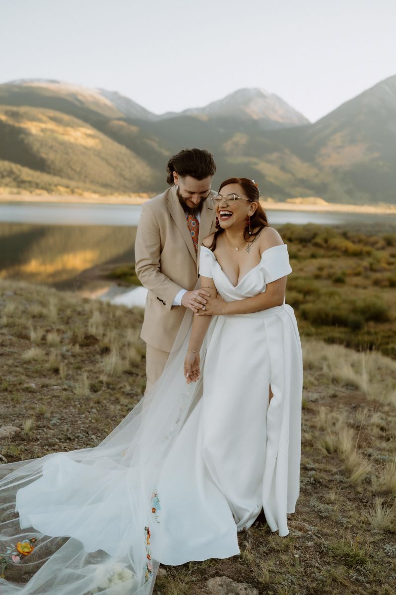 a couple laughing together they are having an elopement at twin lakes in colorado 